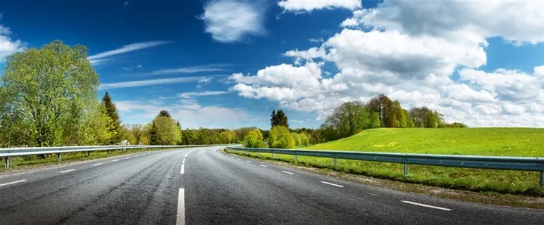蓝天白云下草地上的柏油马路 蓝天白云下草地上的柏油马路