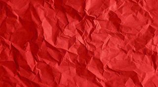 红色褶皱纸张纹理背景