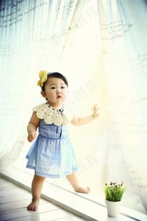 站在窗旁的可爱小女孩
