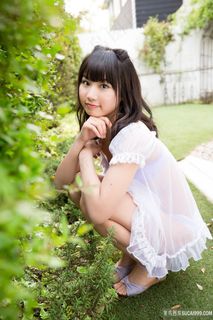 蹲在草地上的日本清纯美女图片