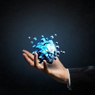 灰色背景下的西装男子手中的蓝色魔方高清摄影