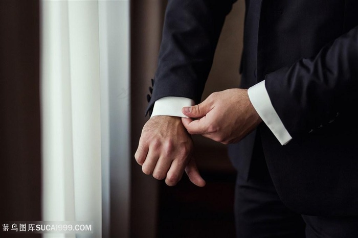 穿西服整理衣袖的成熟商务男人图片