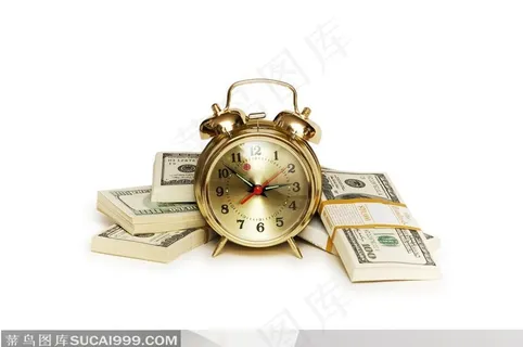 金色的小闹钟和成捆的美钞 金色的小闹钟和成捆的美钞