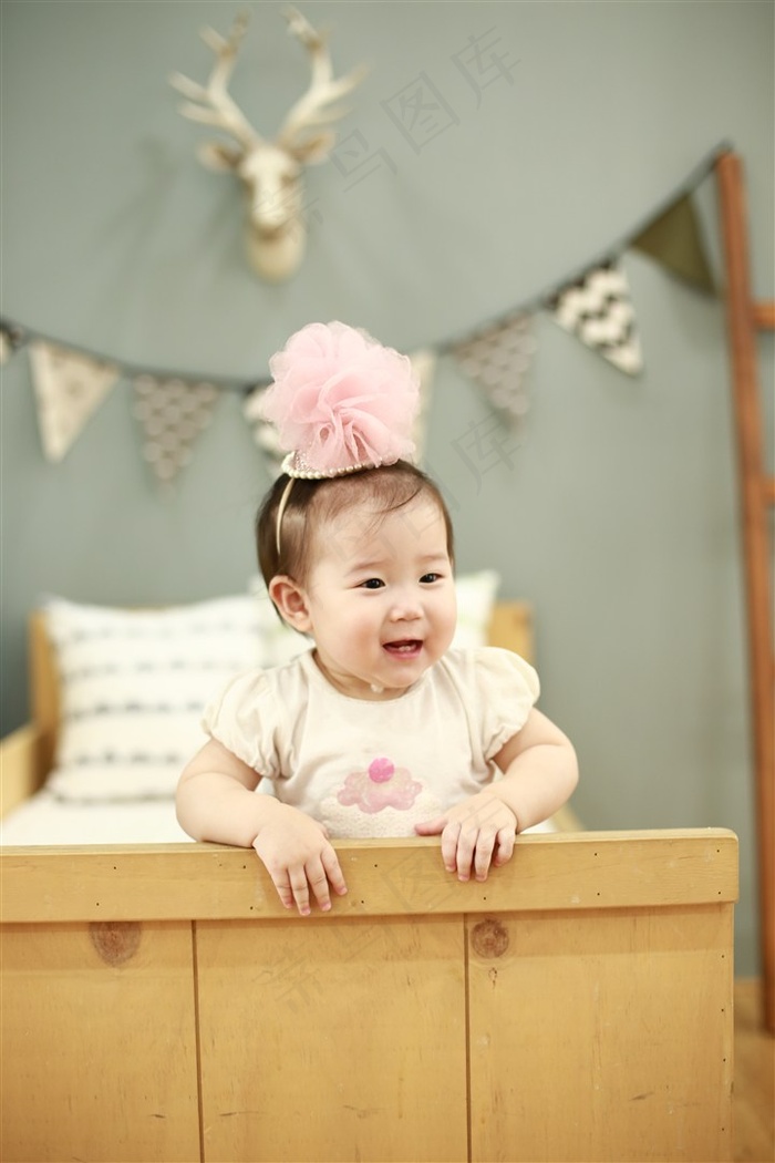 戴上粉红色绵球的可爱幼儿