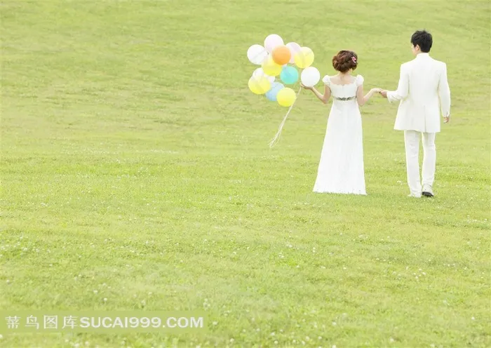 草地上牵手拉气球的情侣婚纱摄影