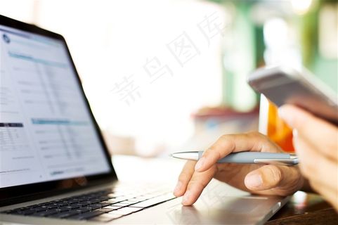 一边工作一边看手机的男人