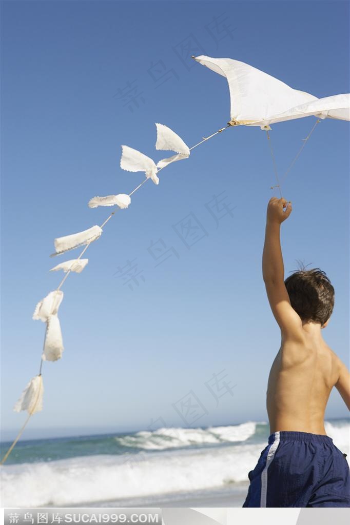 家庭海滩旅-在海边放风筝的小男孩