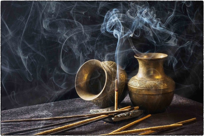 金色器皿与点燃后的香摄影高清图片