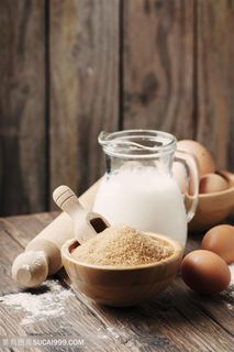 桌子上摆放着鸡蛋面粉和牛奶高清摄影图片