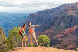 攀登上山顶旅游的情侣高清图片