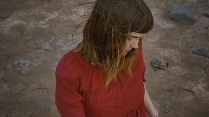 坐在沙漠中伸展身体的女孩