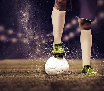 足球场上踩着足球的运动员高清图片