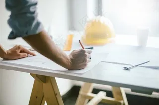 白色桌上画图的男子高清摄影图