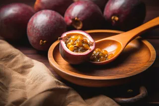 百香果勺子挖开水果摄影图