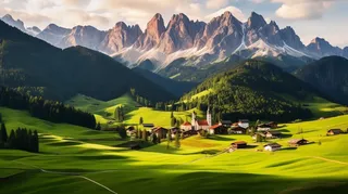 新疆雪山山下的山谷村庄风景摄影图