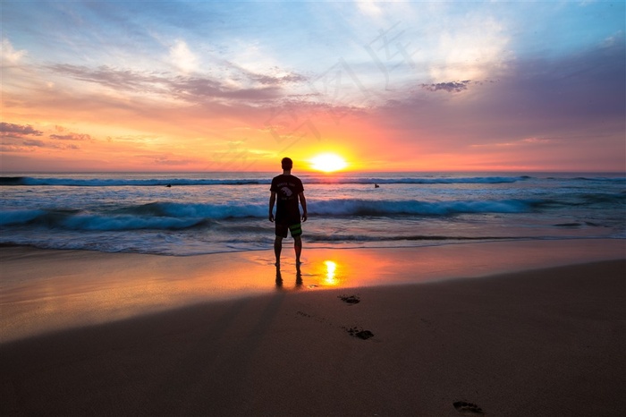 海边远眺夕阳的人