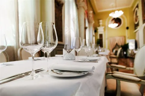 高档餐厅内的白色长方形餐桌餐具摆设高清图片