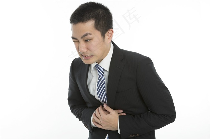 双手捂着胃部的商务人士高清图片
