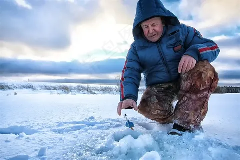 冰面上垂钓的外国男子高清摄影图