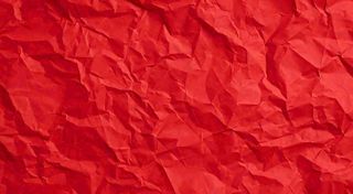 红色褶皱纸张纹理背景