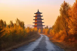 秋季金黄的树叶树木道路尽头塔摄影图