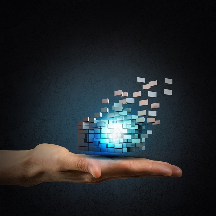 灰色背景中单手手掌上的蓝色小球高清摄影图片