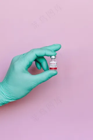 手拿新冠疫苗瓶图片
