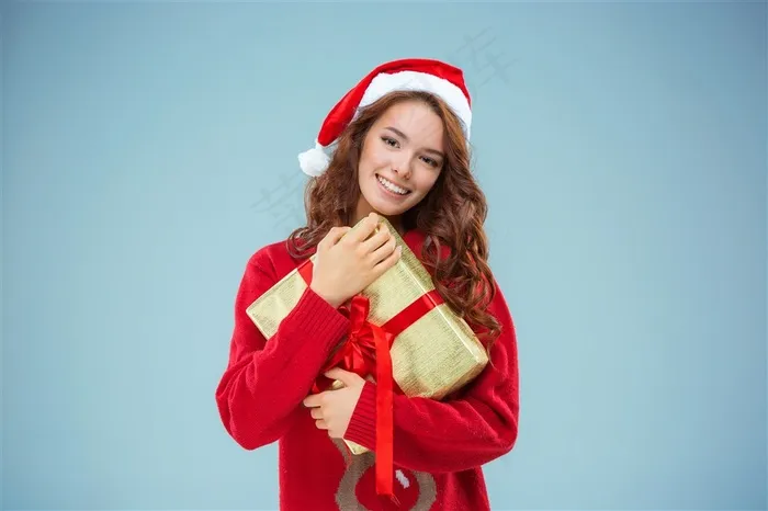 把礼物抱在怀里的圣诞装扮女性高清摄影图片