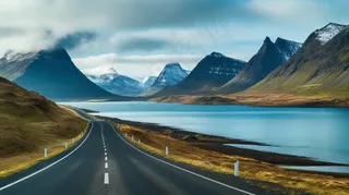 雪山下的公路湖泊河流高山摄影图