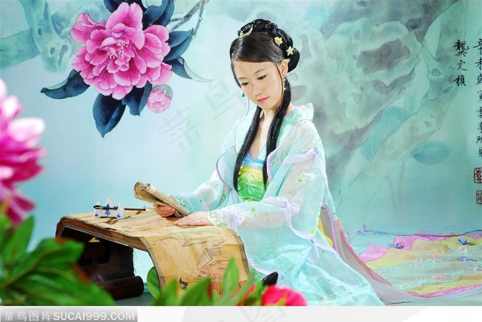 穿传统服装汉服的古典美女坐书桌前读书