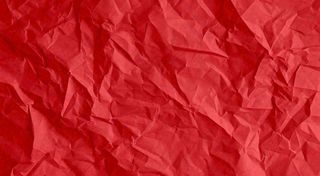 红色褶皱纸张纹理背景
