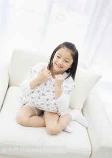 坐在沙发上抱着靠垫的女孩