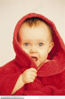 红毯中露出惊讶神情的婴儿