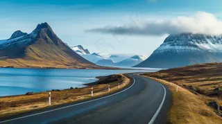 雪山下的公路湖泊河流高山摄影图