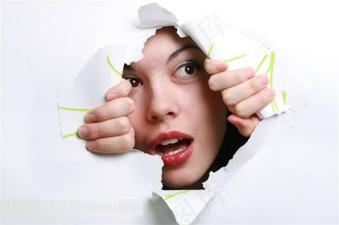 两手破纸的做惊讶状的人物摄影素材