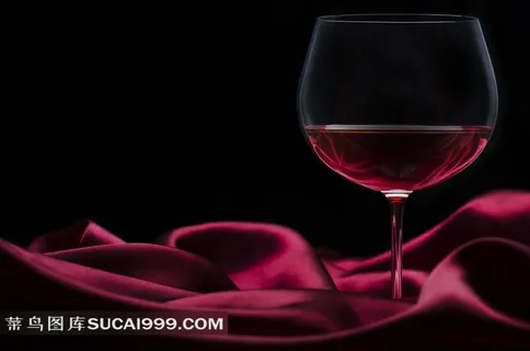 红酒杯子与酒红色布料图片