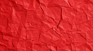 红色褶皱纸张纹理背景