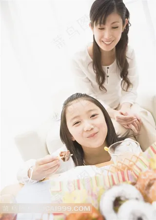 在妈妈身边享受美食的小女孩