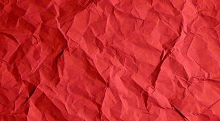 红色褶皱纸张纹理背景
