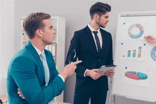 两位职员面对演示文件进行讨论的高清摄影图片