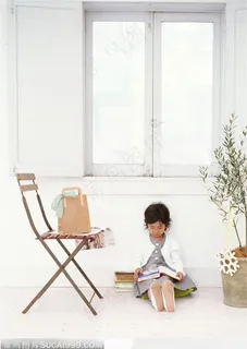 坐在窗台下面看书的小女孩