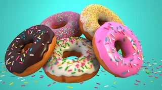 甜甜圈彩色甜点蓝色背景摄影图