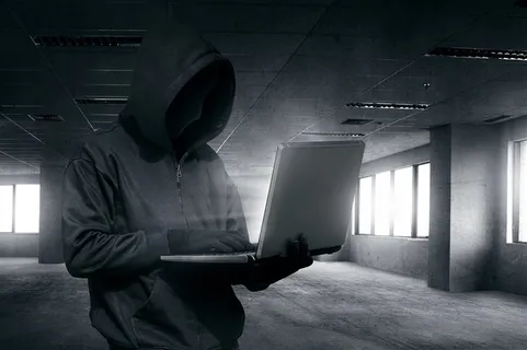 站在水泥建筑中操作电脑的黑客高清图片 站在水泥建筑中操作电脑的黑客高清图片