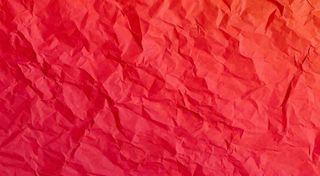 红色褶皱纸张纹理背景