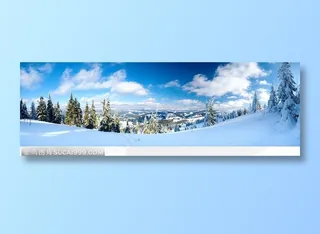 宽幅蓝天白云下的雪地树林