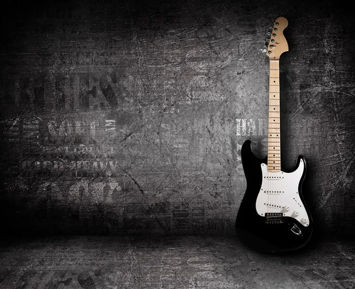 黑色墙角里的吉他高清摄影图片