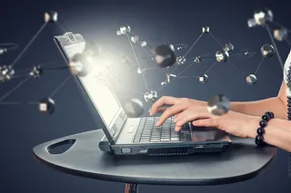 笔记本电脑周围的原子结构背景