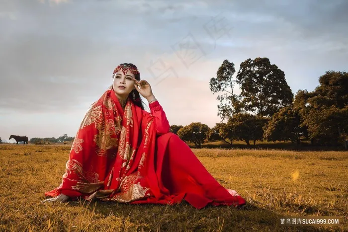 坐在草地上的红裙子美女