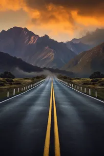 一条通往远方的公路远处是山峰摄影图