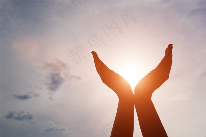 捧着太阳的手部剪影高清图片